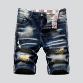 Distressed whiskered men's denim shorts