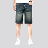 Whiskered dark denim shorts